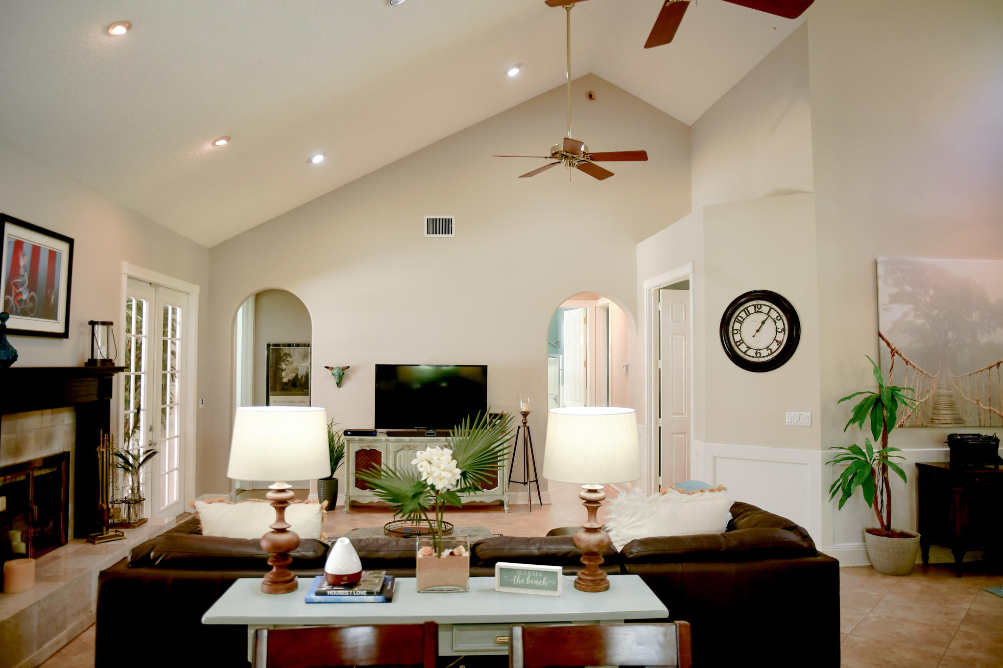 18263 River Oaks Drive Jupiter, FL 33458 - Photo 7 of 24 a living room with furniture a flat screen tv and a fireplace