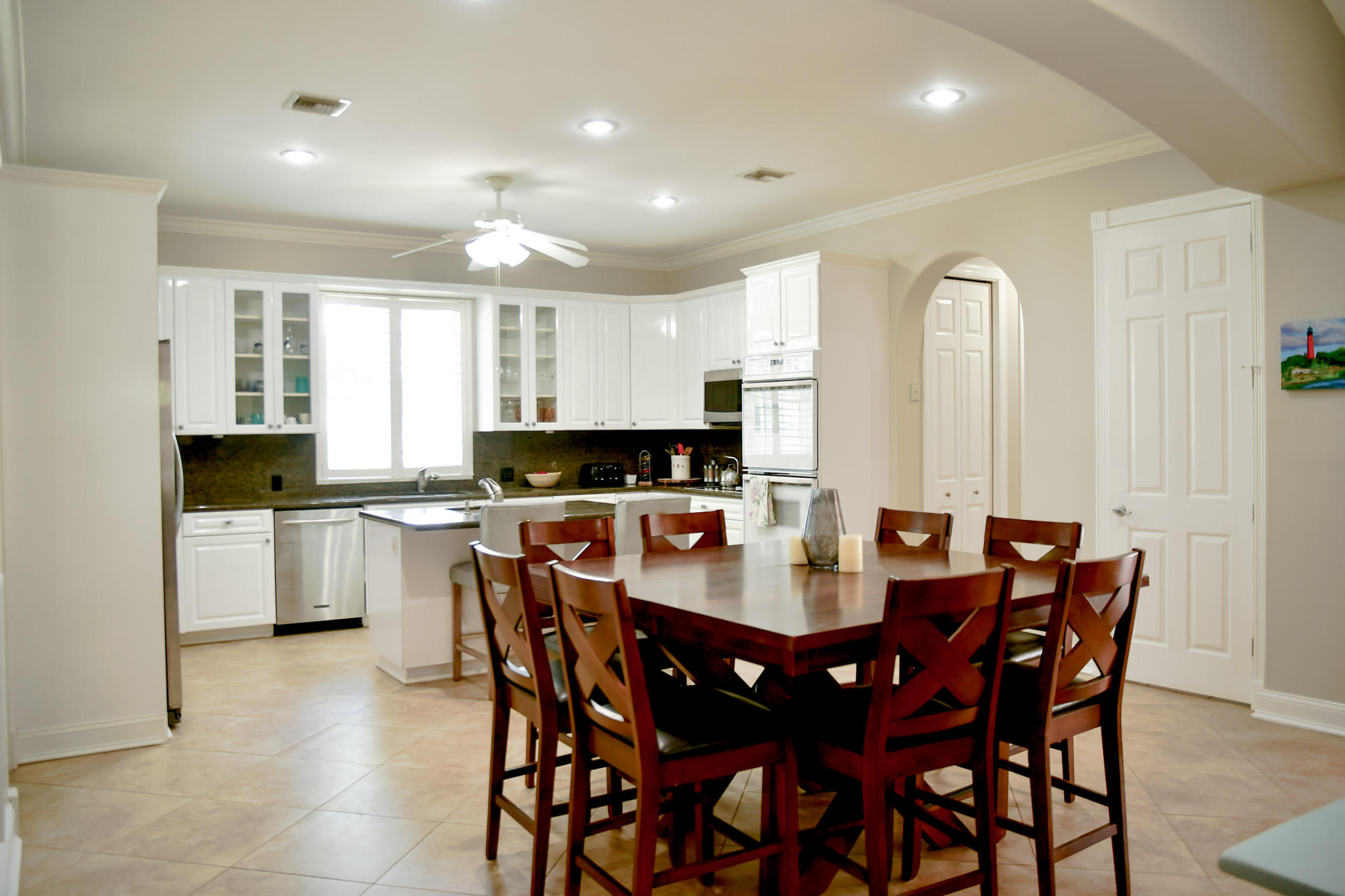 18263 River Oaks Drive Jupiter, FL 33458 - Photo 8 of 24 a large kitchen with a table and chairs