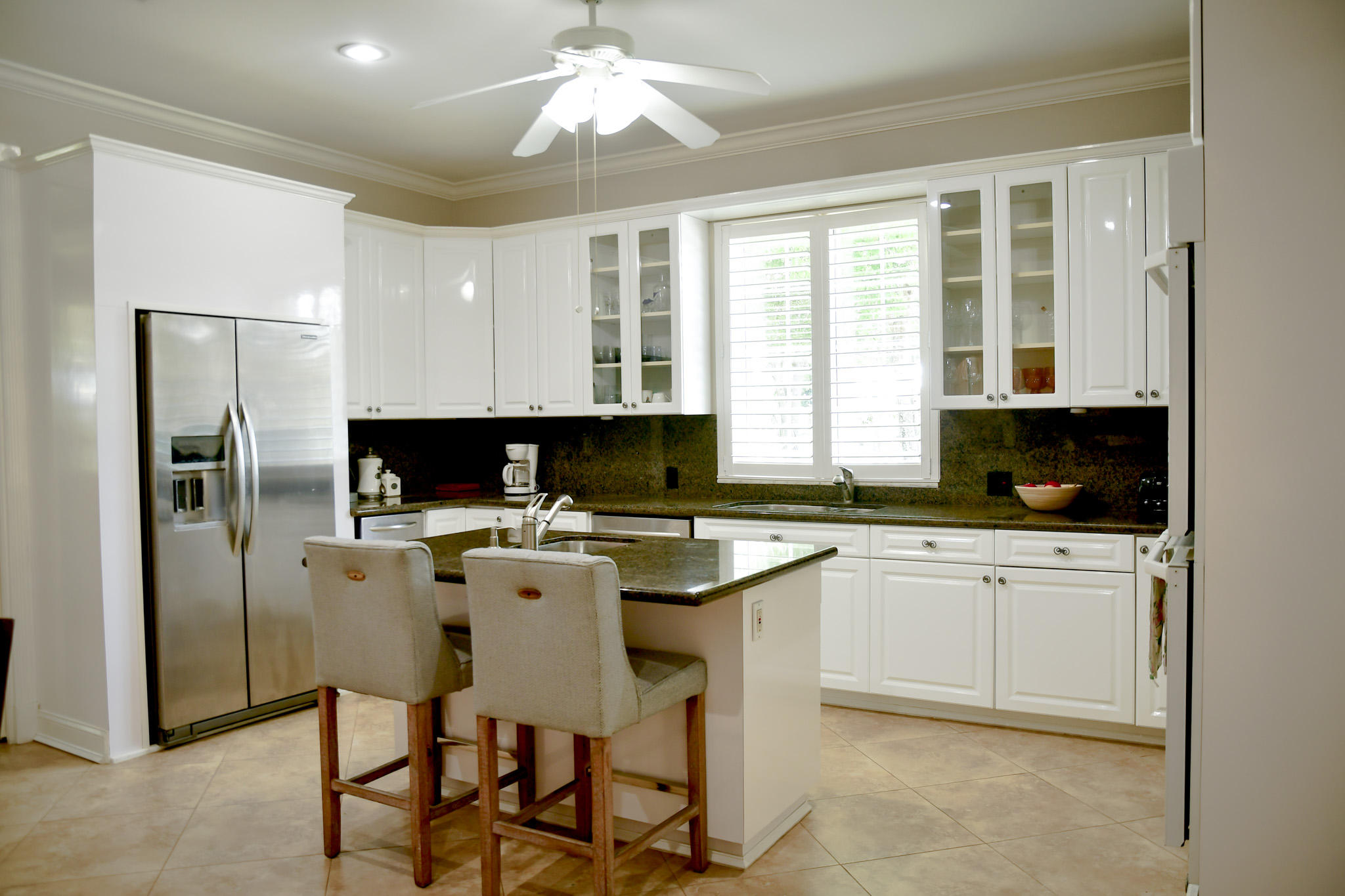 18263 River Oaks Drive Jupiter, FL 33458 - Photo 9 of 24 a kitchen with a center island appliances cabinets and a counter top space