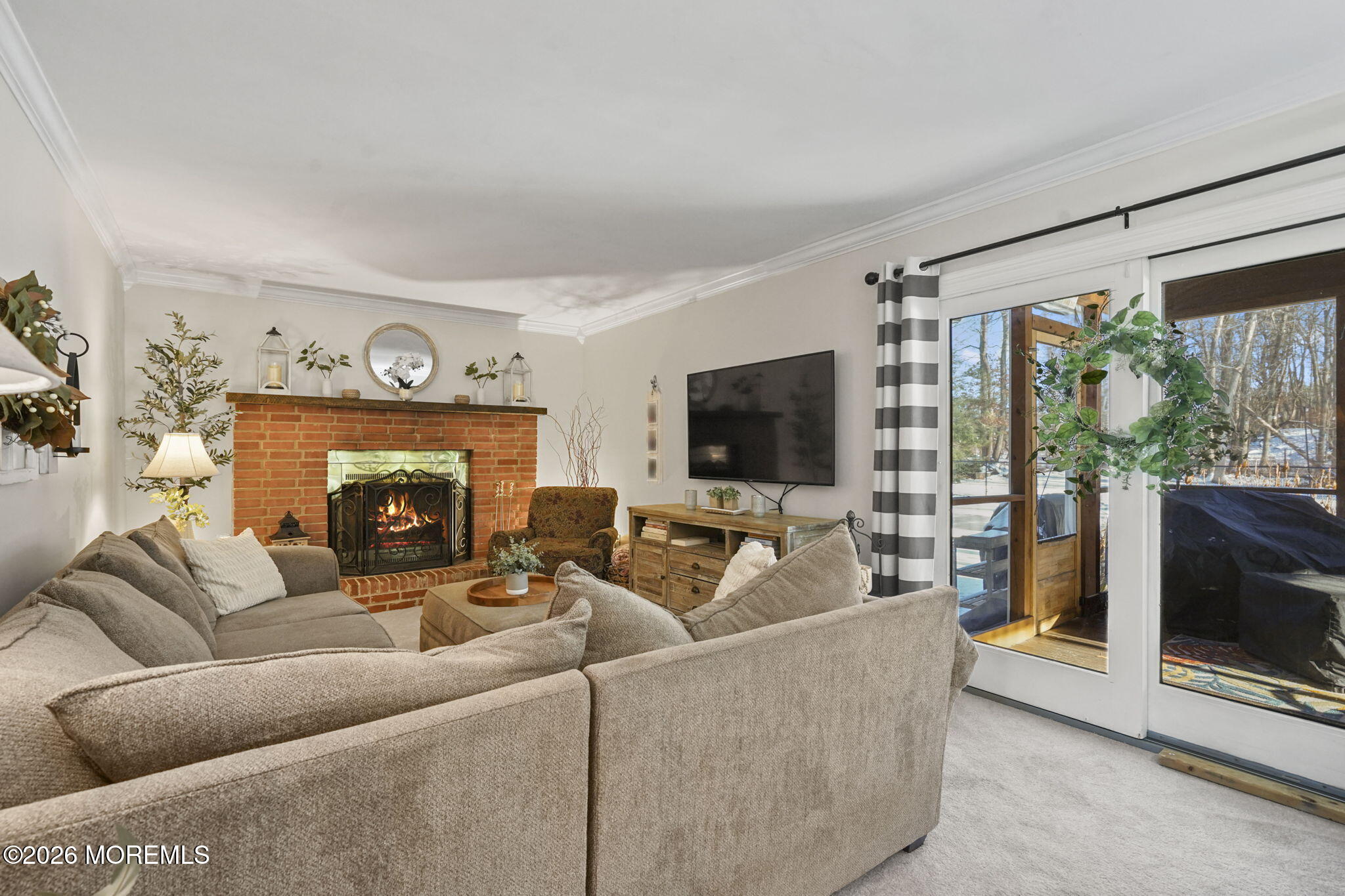 12 Rimwood Lane Howell, NJ 07731 - Photo 11 of 34 a living room with furniture a flat screen tv and a fireplace