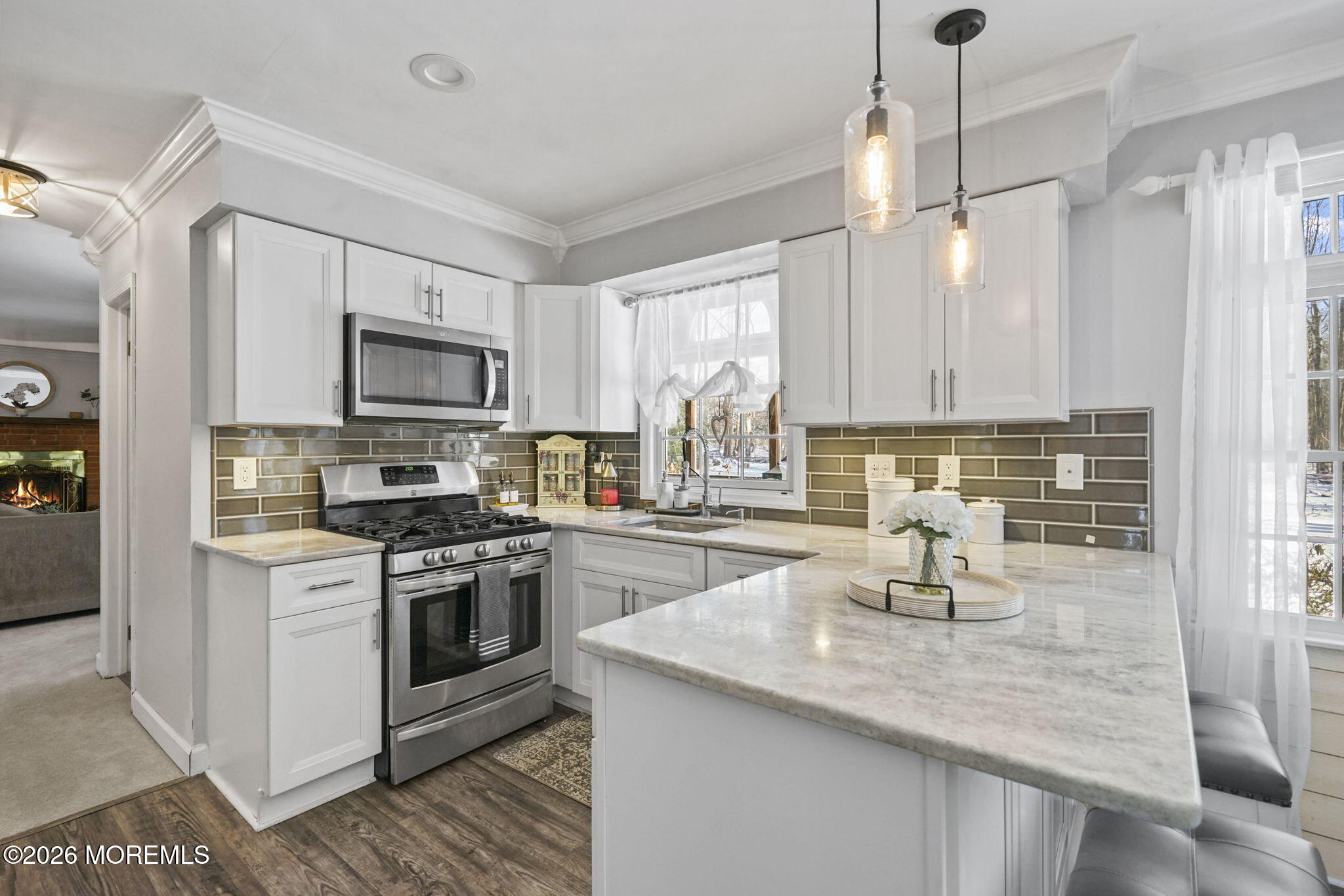 12 Rimwood Lane Howell, NJ 07731 - Photo 4 of 34 a kitchen with sink a stove and cabinets