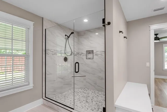 a bathroom with a glass shower door