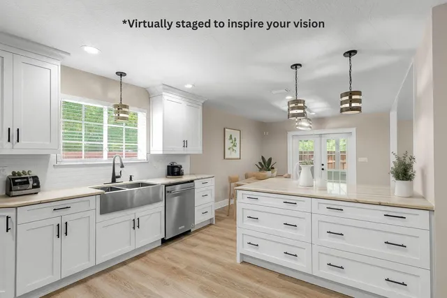 a kitchen with a sink stove and cabinets
