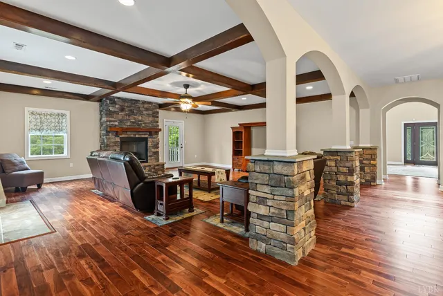 a living room with a couch and dresser with wooden floor