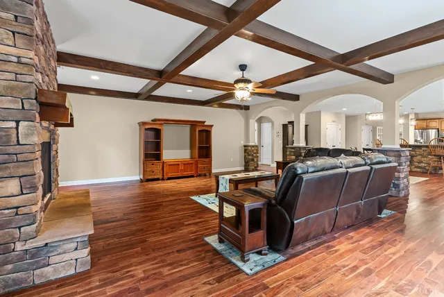 a view of a hallway with wooden floor windows and a livingroom
