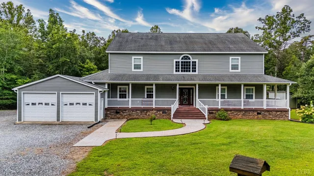 a front view of a house with a yard table and chairs