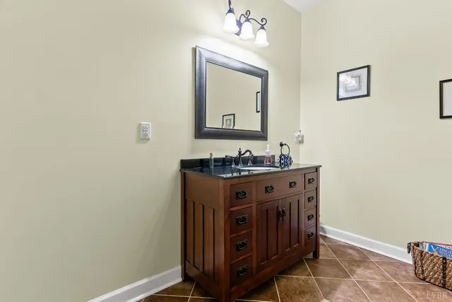 a view of a large pool with lawn chairs under an umbrella