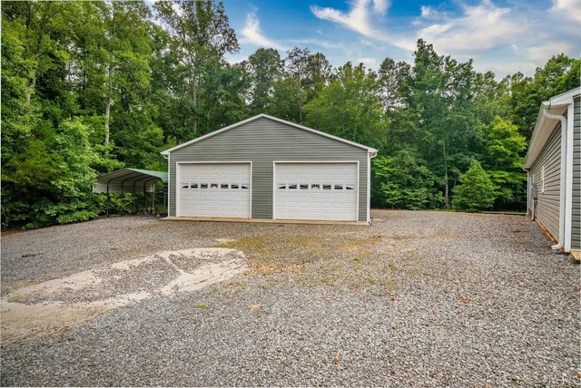 a view of a house with a yard and garage