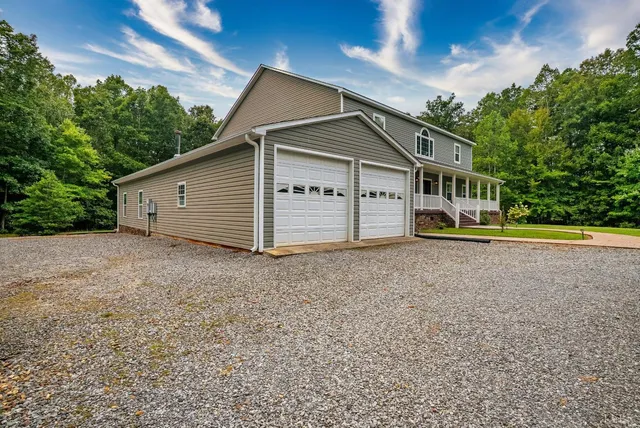 an aerial view of a swimming pool with a yard