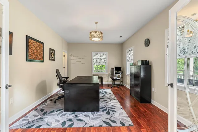 a view of a dining room with furniture and wooden floor