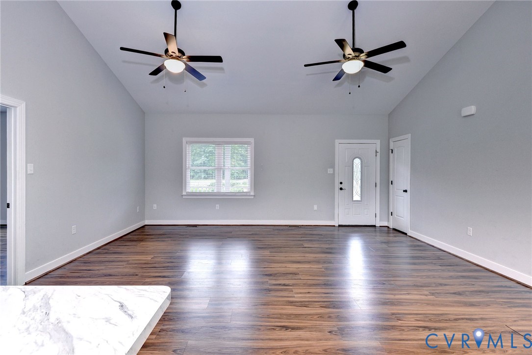 8904 Rock Cedar Road New Kent, VA 23124 - Photo 6 of 37 a view of an empty room with a window and wooden floor