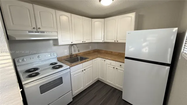 a white refrigerator freezer sitting inside of a kitchen