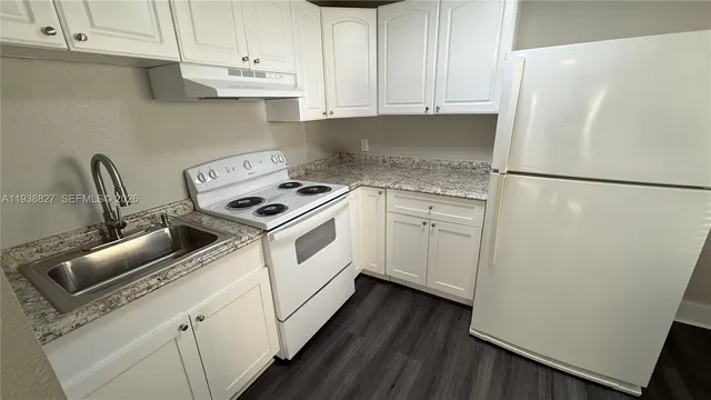 a white refrigerator freezer sitting inside of a kitchen