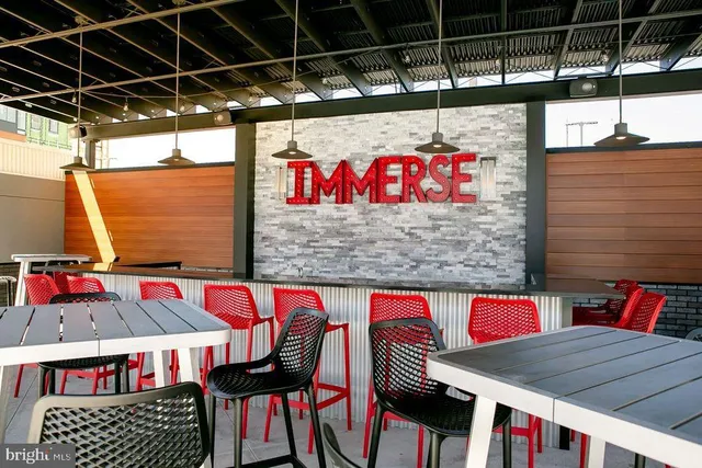 a patio with a table and chairs under an umbrella