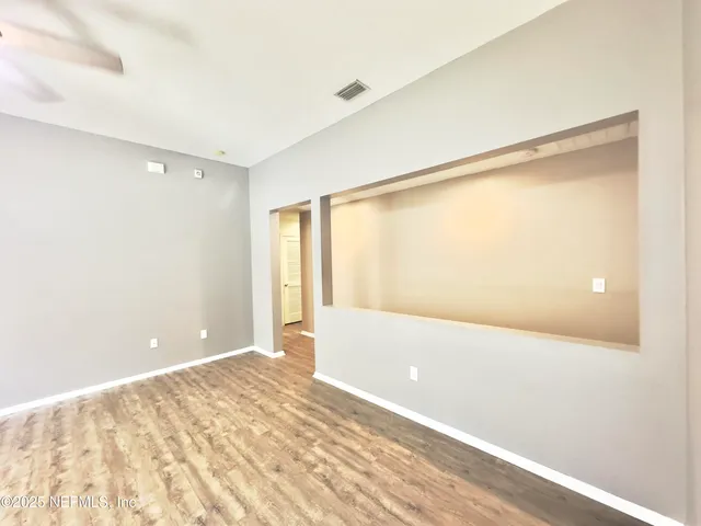 a view of an empty room with a window