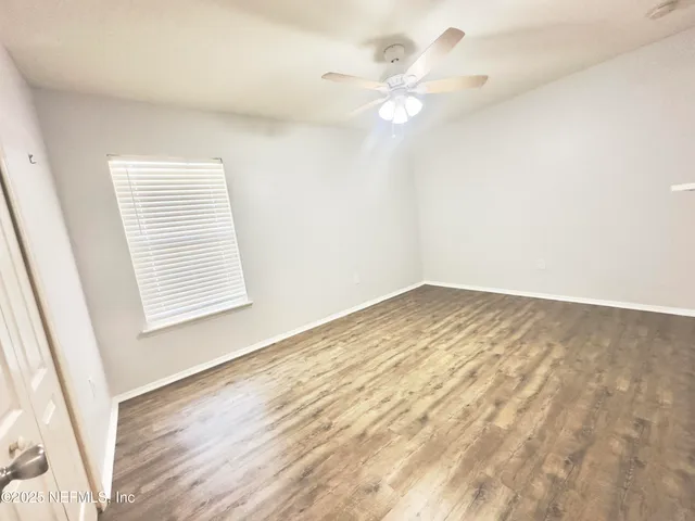 wooden floor in an empty room with a window