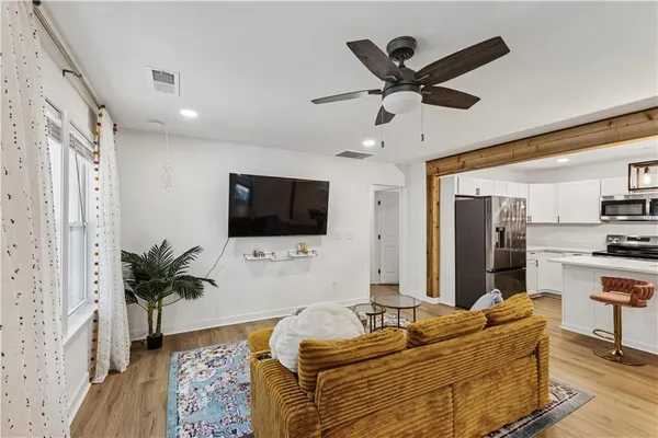 a living room with furniture and a flat screen tv