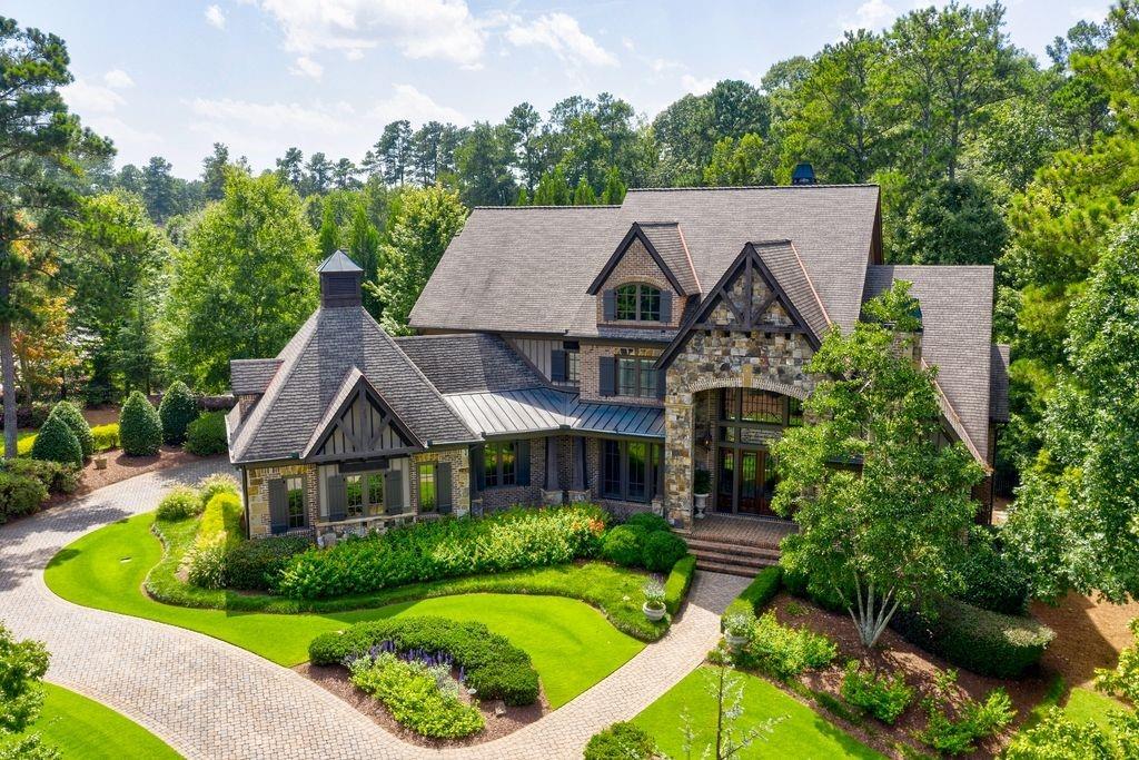 Brick-n-stone estate sits proudly on corner lot.