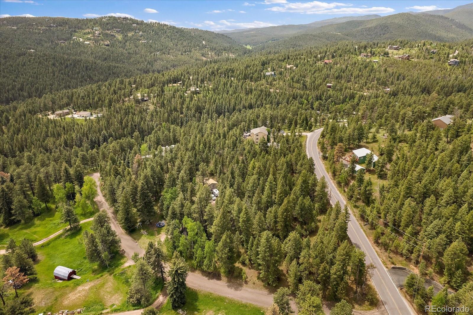 30540 Cobb Road Evergreen, CO 80439 - Photo 8 of 12 an aerial view of residential houses with outdoor space and trees