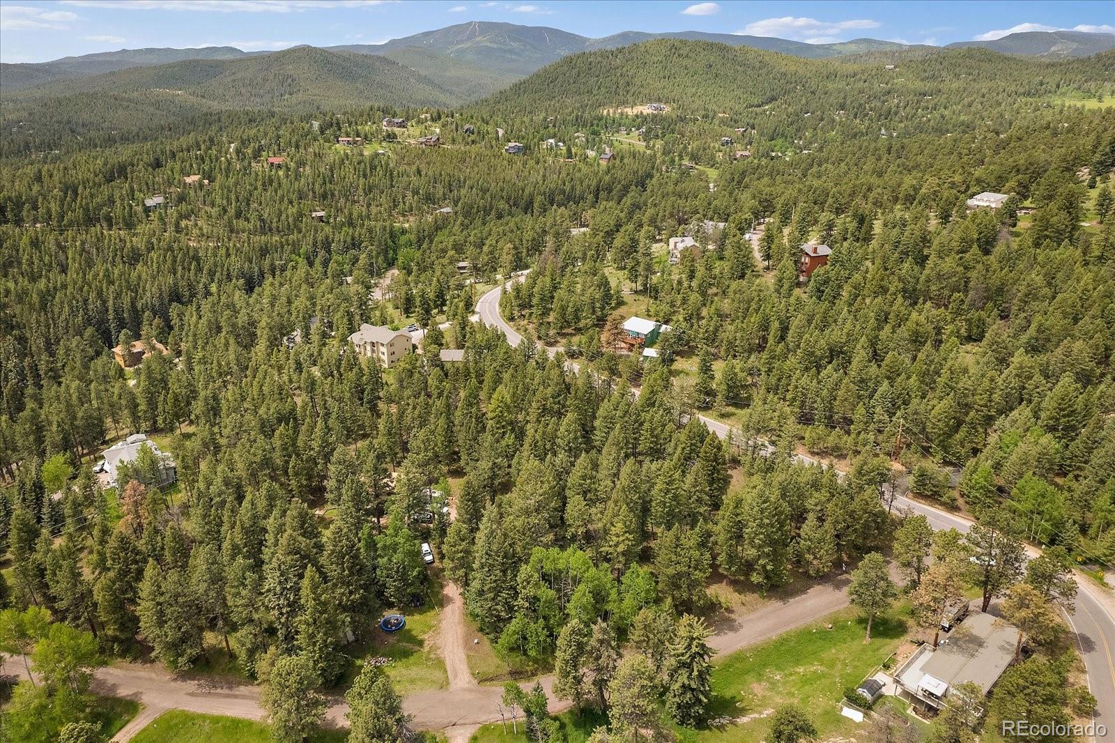 30540 Cobb Road Evergreen, CO 80439 - Photo 9 of 12 a view of a field with mountains in the background