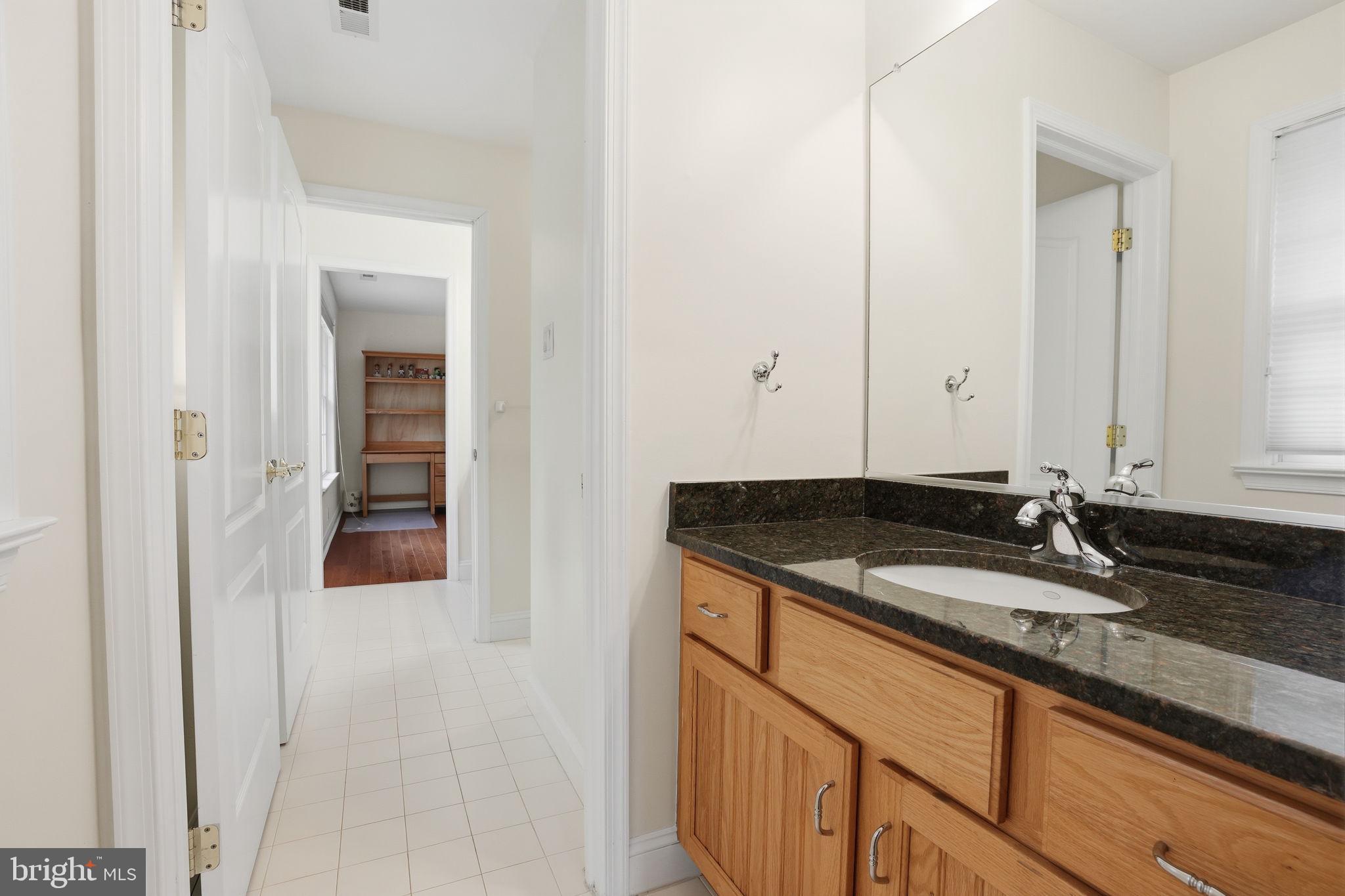 1588 Wrightstown Road Newtown, PA 18940 - Photo 60 of 81 a bathroom with a granite countertop sink and a mirror