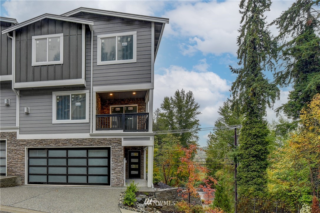 22806 23rd Avenue Southeast, Unit 1 Bothell, WA 98021 - Photo 1 of 20 a front view of a house with a garden