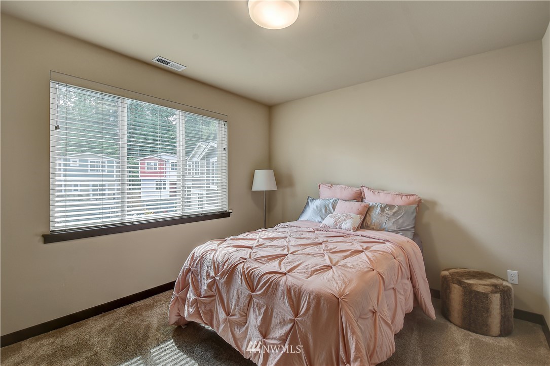 22806 23rd Avenue Southeast, Unit 1 Bothell, WA 98021 - Photo 14 of 20 a bed sitting in a bedroom next to a window