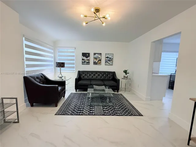 a living room with furniture rug and window
