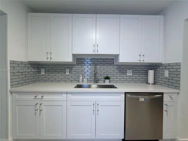 a kitchen with white cabinets