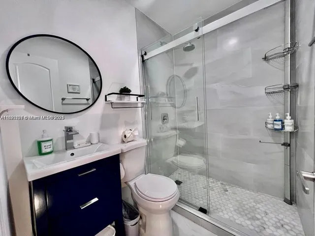 a bathroom with a sink toilet and a mirror