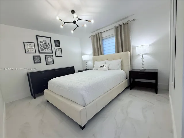 a bedroom with a bed and lamp
