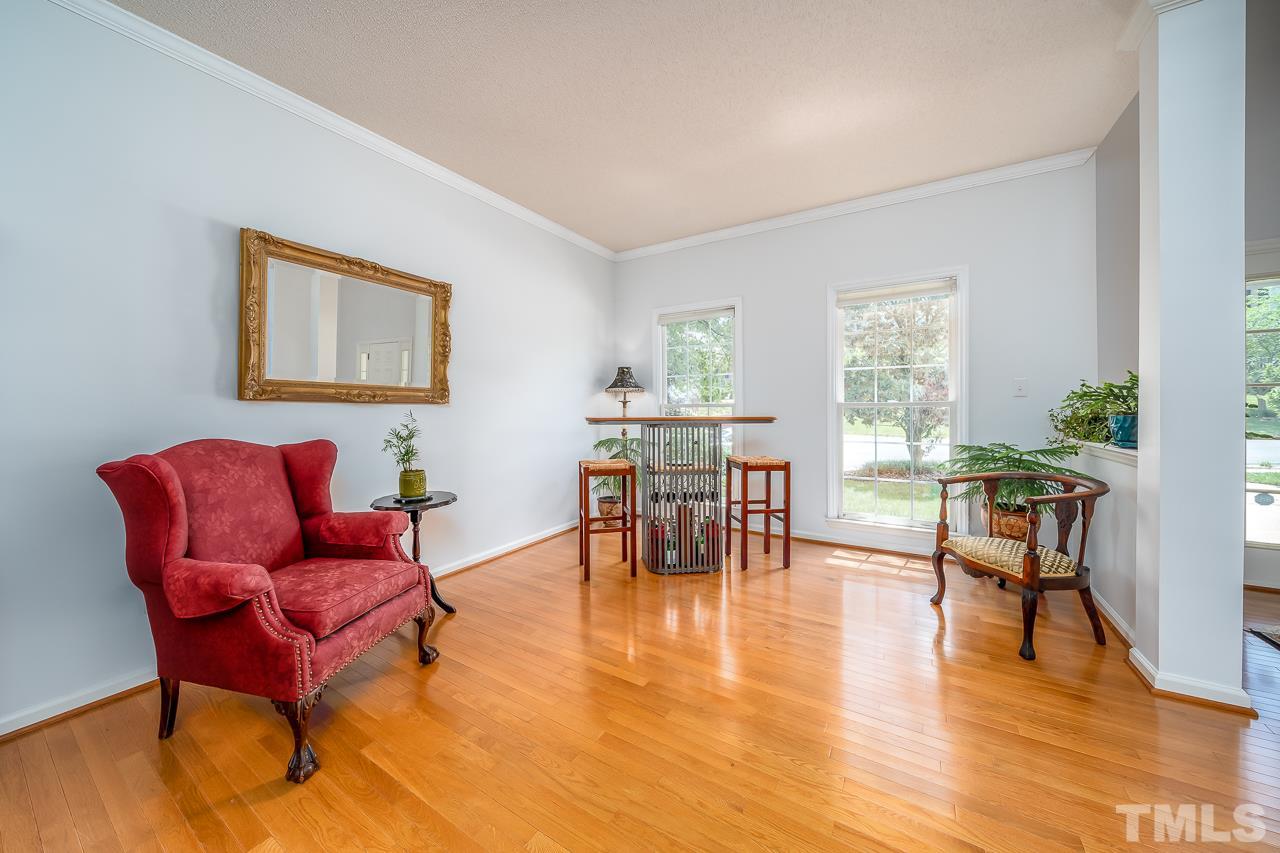 2308 Bolingbrook Lane Raleigh, NC 27613 - Photo 15 of 30 a living room with furniture and a table with wooden floor