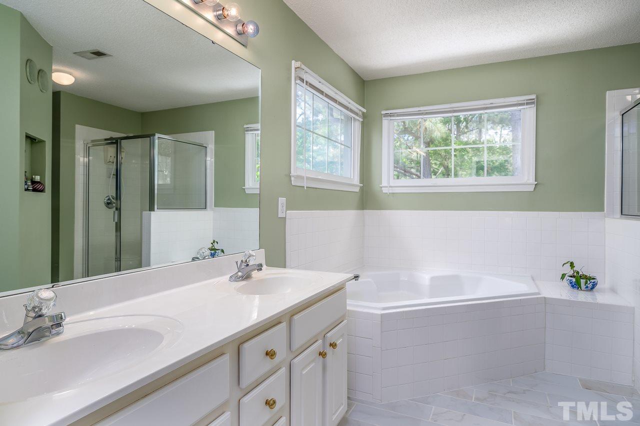 2308 Bolingbrook Lane Raleigh, NC 27613 - Photo 19 of 30 a bathroom with a tub a sink and mirror