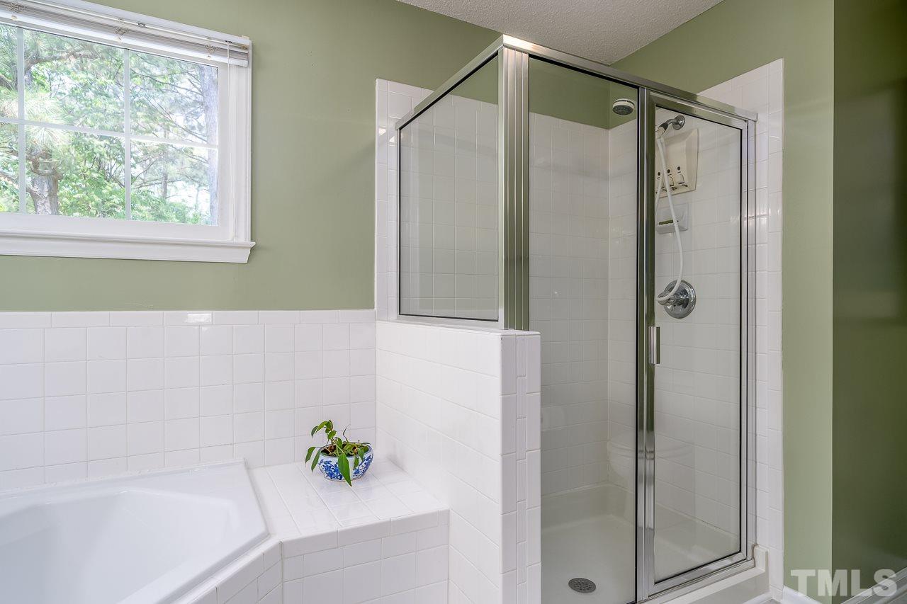 2308 Bolingbrook Lane Raleigh, NC 27613 - Photo 20 of 30 a bathroom with a shower and a bathtub