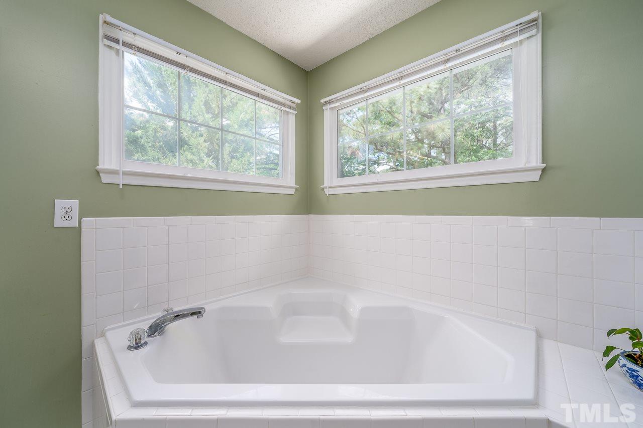 2308 Bolingbrook Lane Raleigh, NC 27613 - Photo 21 of 30 a bathroom with bathtub and window