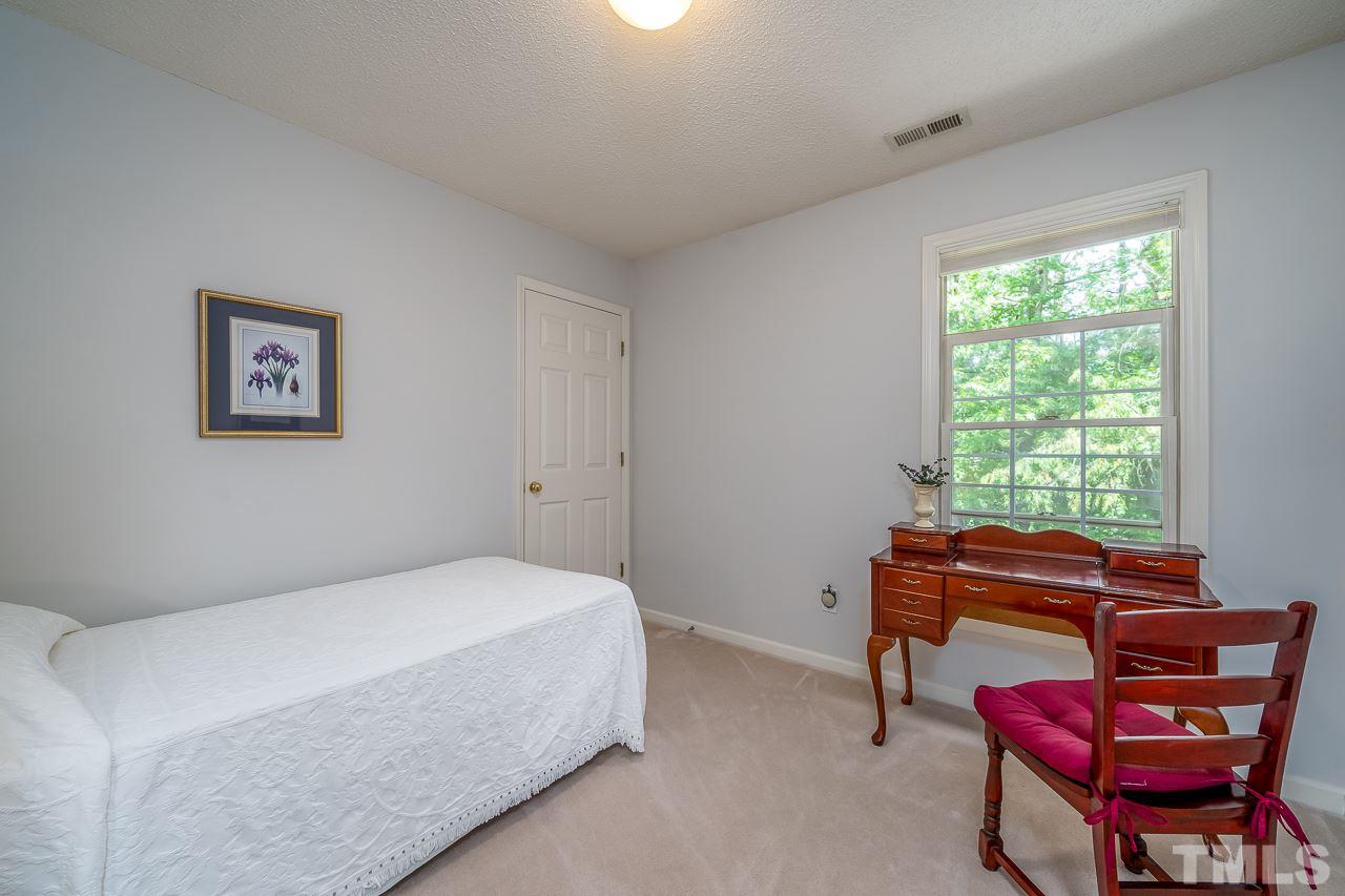 2308 Bolingbrook Lane Raleigh, NC 27613 - Photo 25 of 30 a bedroom with a bed and a window