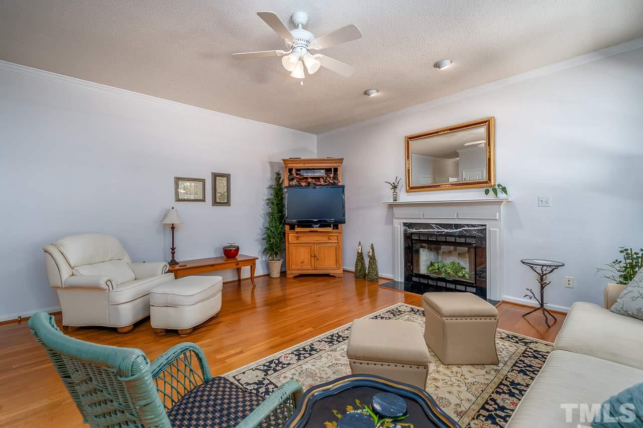 2308 Bolingbrook Lane Raleigh, NC 27613 - Photo 5 of 30 a living room with furniture a fireplace and a window