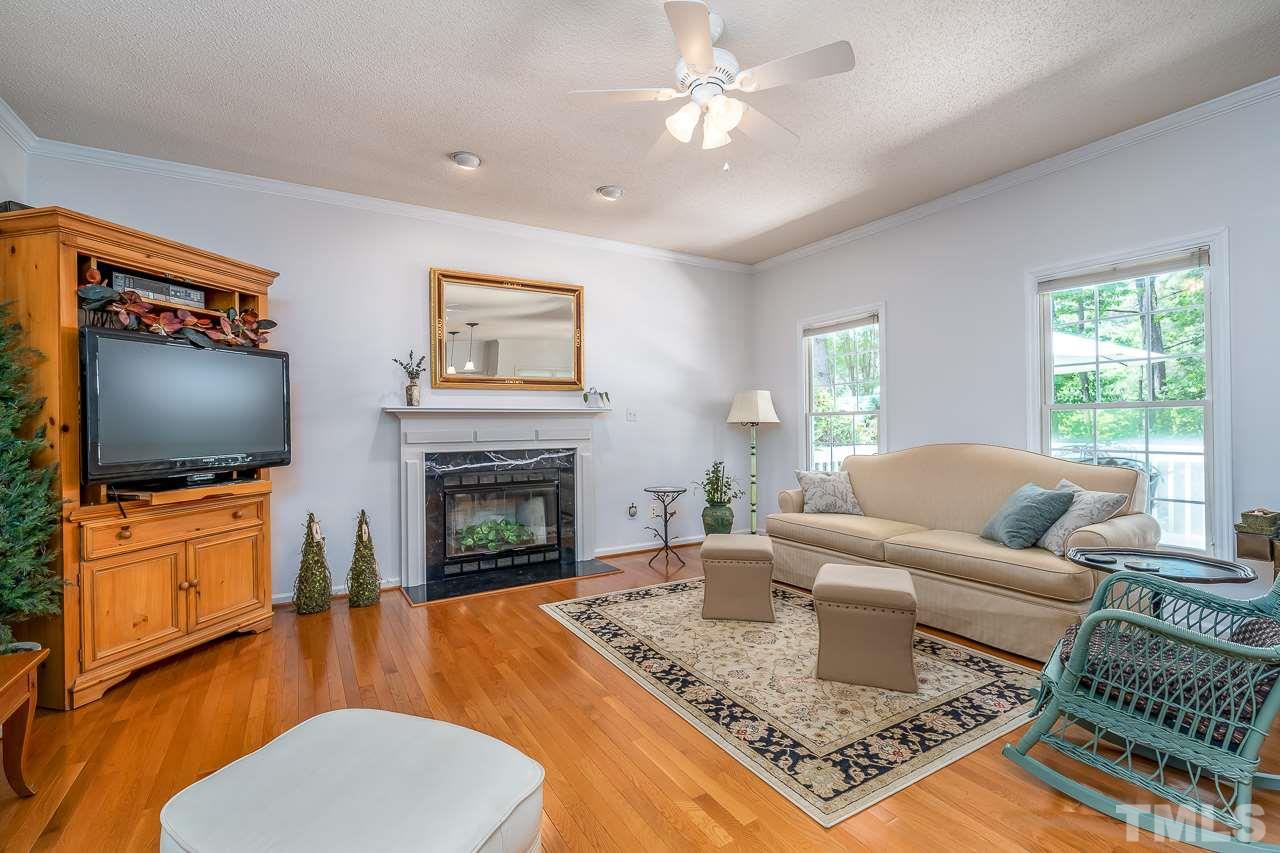 2308 Bolingbrook Lane Raleigh, NC 27613 - Photo 6 of 30 a living room with furniture a flat screen tv and a fireplace
