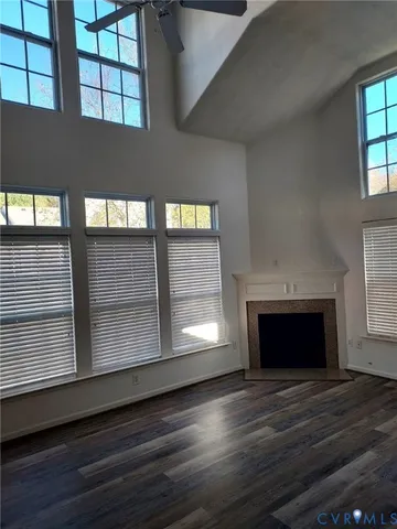 a view of an empty room with a fireplace and a window