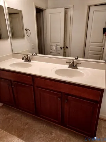 a bathroom with a double vanity sink and a mirror