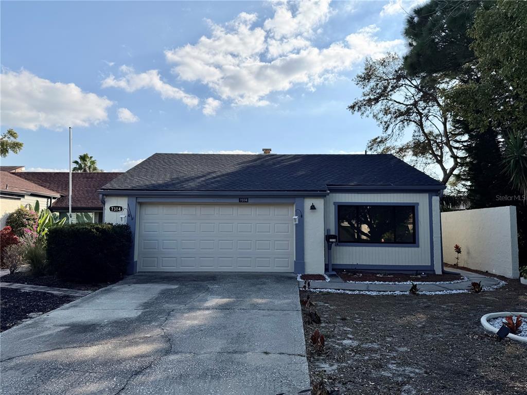 7314 Patio Row Hudson, FL 34667 - Photo 1 of 17 a front view of a house with garden