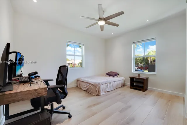 a bedroom with a bed and a desk
