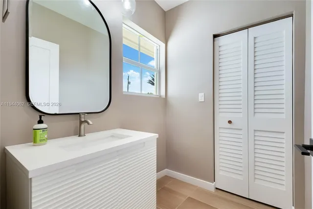 a bathroom with a sink and a mirror