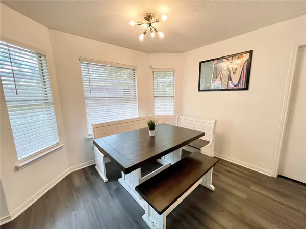 a room with pool table and windows