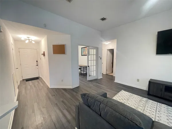 a living room with couches and a flat screen tv
