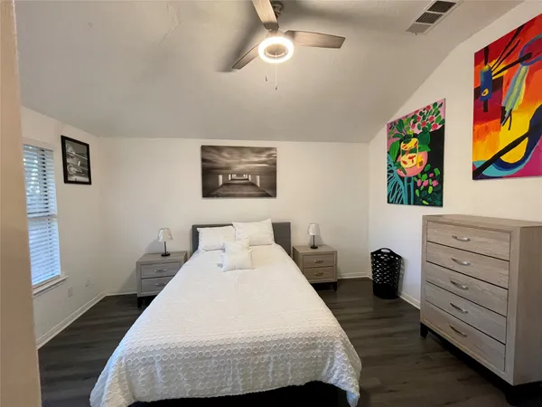 a bedroom with a bed and dresser