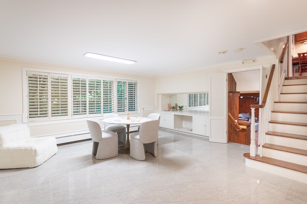 110 Robin Road Weston, MA 02493 - Photo 25 of 40 a view of a dining room with furniture and a large window