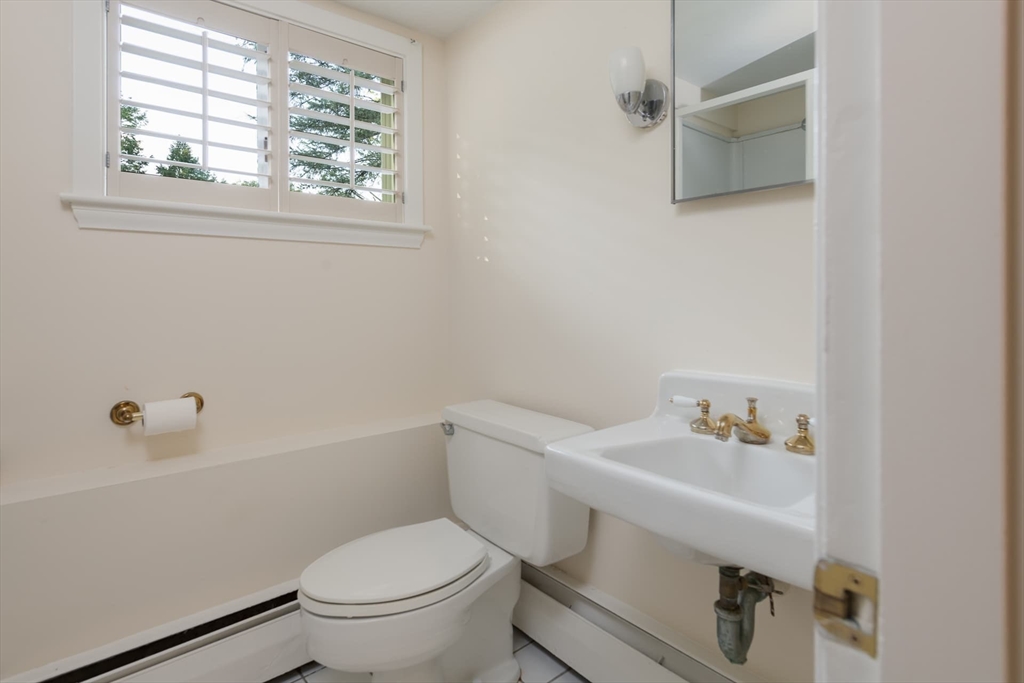 110 Robin Road Weston, MA 02493 - Photo 27 of 40 a white toilet sitting next to a bathroom sink
