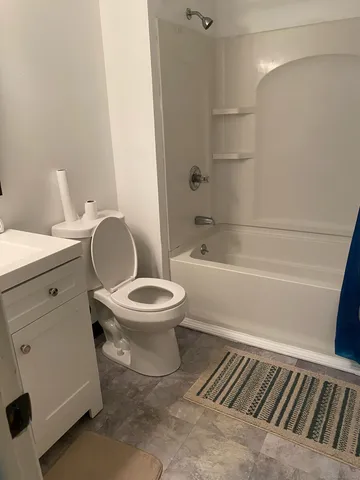 a bathroom with a toilet a sink and bathtub