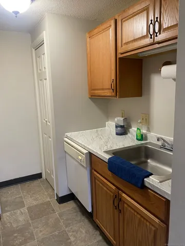 a kitchen with stainless steel appliances granite countertop a sink and a cabinets